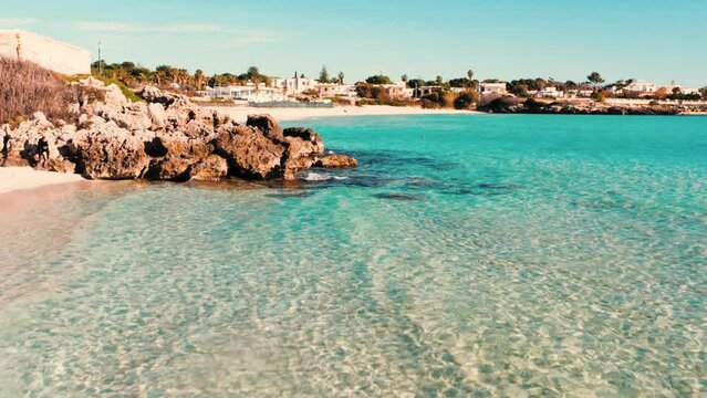 Salento, spiaggia con mare blu cristallino, marina di pulsano, Taranto, Puglia, Italy - drone 4K