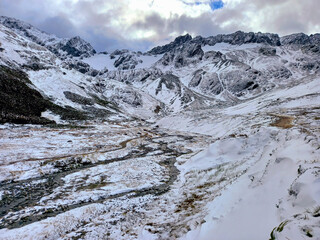 Panoramic of glaciers and snow-capped mountain range of the Andes. Icy forest track. Glaciers and...