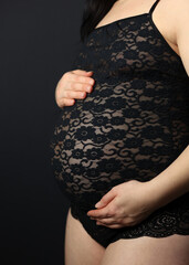 Pregnant woman in underwear. She is 30 weeks pregnant and has a big belly. Expecting a child. Third pregnancy