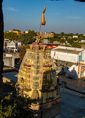 Stone Temple in Koteshwar with pendant on top and Koteshwar town in background