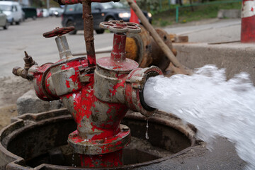 Water flows from faucet and pipe. Draining water from building plumbing system