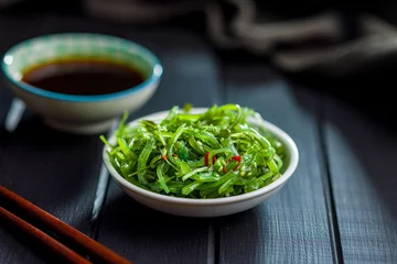Foto op Canvas Green seaweed. Japanese wakame salad in bowl. © Jiri Hera