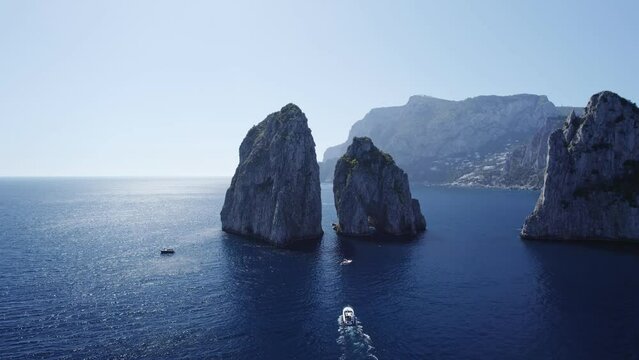 capri island Faraglioni Rocks and alone boat drone view
