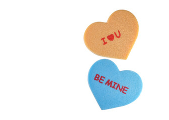 Two foam hearts with I love u and Be mine texts on white background.