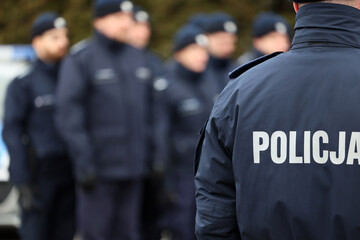 Zimowy mundur policjanta z napisem policja na plecach. 