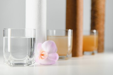 Water filters concept. Carbon cartridges and a three glasses on a white background. Household...