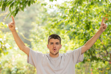 young man outdoors with a successful expression