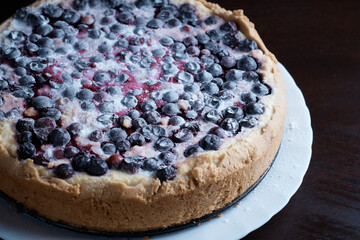 freshly baked berry pie on dark background, close-up, dessert with fresh fruit, hot, steaming