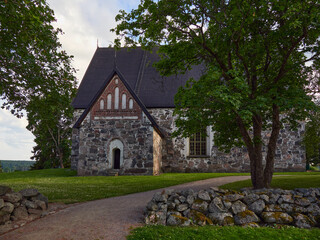 Fototapeta na wymiar Exterior of old medieval Lutheran church in Finnish Sipoo.