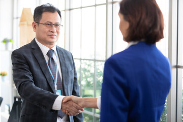 businessman shaking hands with partners after successful a job in the office