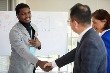 African businessman shaking hands to seal a deal with partner in the office