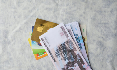 plastic bank credit and debit cards and Russian rubles on a white background. transition of the economy to non-cash payments and e-commerce.