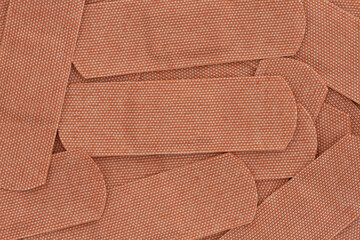 Lots of fabric adhesive band aids background