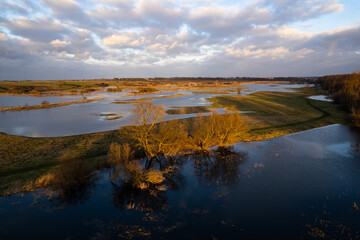 Sunset over flooded fields. Sunset reflection in submerged fields. Submerged fields. Afternoon sun reflection in submerged fields.