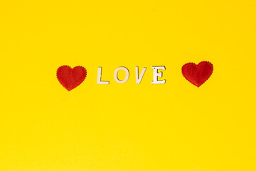 Happy Valentine's day. 14 February. Love. Red hearts on a yellow background.
