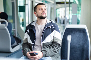 Portrait of male passenger in tram car on a spring day