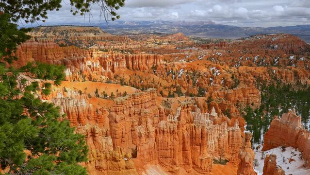 Bryce Canyon National Park, Utah, USA. Giant orange hoodoos and natural amphitheaters, partly covered with snow in Bryce Canyon NP. Zoom out shot