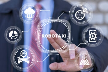 Businessman using virtual touch screen presses word: ROBOTAXI. Concept of Robotaxi Robotic Taxi....