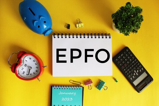 Employees provident fund organisation symbol. EPFO text on open notepad on office wooden table with different stationery.