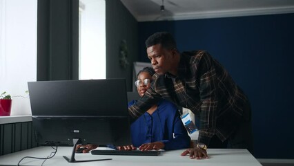 black supervisor controlling work of junior data analyst woman in office, coworkers communication - Powered by Adobe