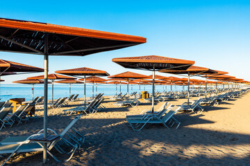 Sunbeds and umbrellas on the sandy beach in Luxury tourist resort