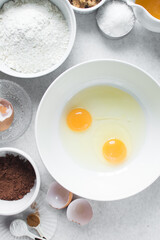 Organic raw eggs in a white mixing bowl for baking  and cooking