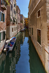 A view of the narrow Venetian water channels winding tightly between the buildings