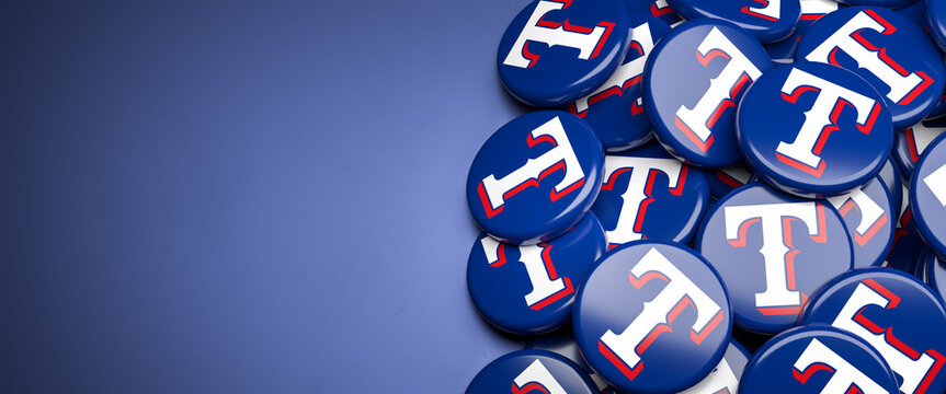 Logos of the American Major League Baseball Team Texas Rangers on a heap on a table.