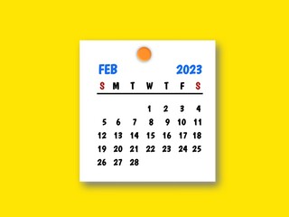 The February 2023 and wooden push pin on yellow background.