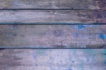Old, cracked, sun-faded boards with peeling and cracked blue and emerald paint. Textured background