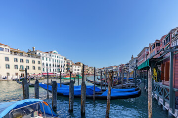 Fototapeta na wymiar View of moored Venetian gondolas waiting for tourists