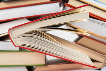 Naklejka premium Opened hardcover book in library, close-up