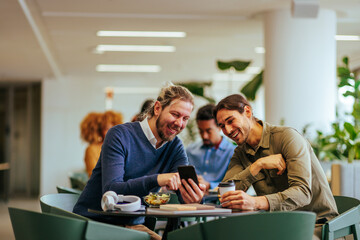 Trendy businessmen on lunch break in cafeteria.
