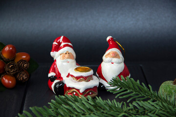 Ceramic Santa Claus. New Year's candlestick. Fir branches.