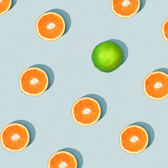 Orange slices with lime on sky blue background