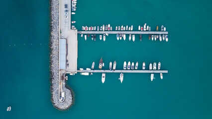 Pier speedboats.This is usually the most popular tourist attractions on the beach.Yacht and sailboat is moored at the quay. Aerial view by drone. A marina lot. A sunny day	
