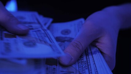 Counting American 100 dollar banknotes. Businesswoman counts the bills of money, rich woman shifting a stack of 100 US dollars by hands.