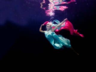Model underwater with long dress and chiffon