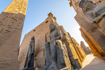 The massive statue of Ramesses II at the entrance to the ancient Luxor Temple, in Luxor, Egypt.