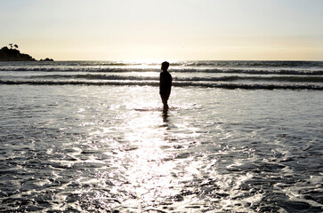 Fototapeta na wymiar HOLIDAYS, PEOPLE ON THE BEACH AT SUNSET