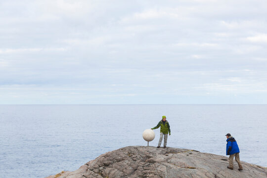 HIkers discover a sculpture of Saturn on Bunes Beach, Moskenesoya, Lofoten Islands, Norway.