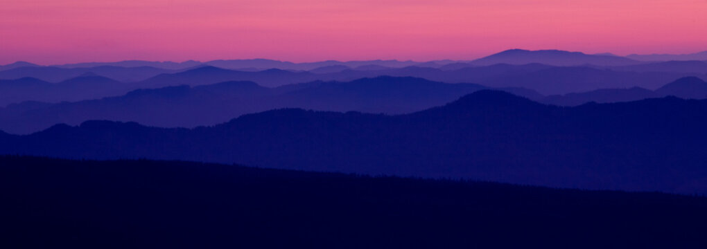 Oregon mountains in the far distance at sunset in Crater Lake National Park.