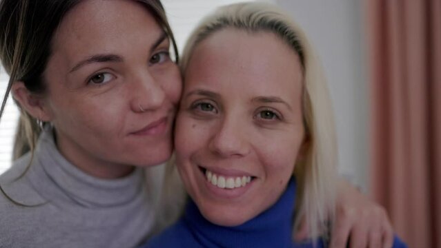 Happy gay lesbian couple having tender moment at home - Lgbt women love concept