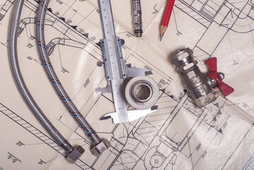 Engineering tools and plumbing details on a technical drawing. Design and production of...
