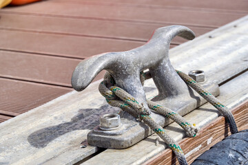 Bita in a harbour, with a ship moored to it.