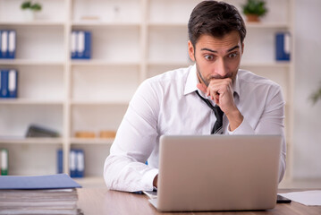 Young male employee working in the office