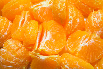 Close up view of freesh peeled orange 
mandarin pieces. Isolated stock photo