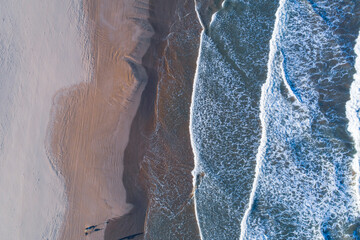 Naklejka premium Aerial view of the beach of valencia and the coastline, late afternoon with waves, Spain