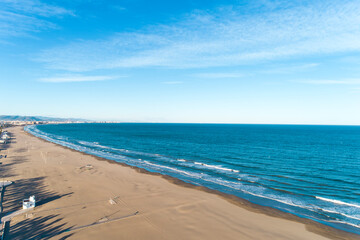 Aerial view of the beach of valencia and the coastline, late afternoon with waves, Spain