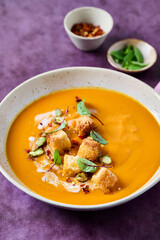 Bowl of pumpkin or carrot soup